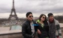 Sarah, Enzo and Derrick get their picture taken at the famous Eiffel Tower