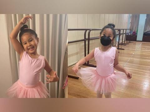 Cute adorable ballerina little girl in pink tutu dance practices