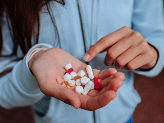 Woman showing vitamins