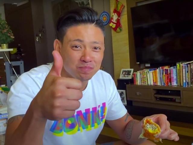 Drew Arellano eating empanada