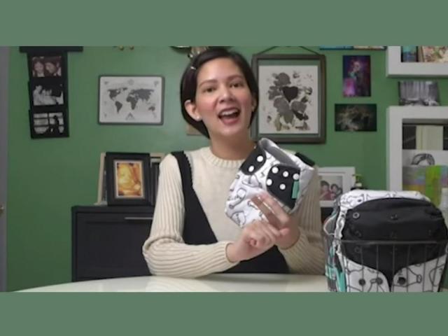 chynna ortaleza holding a cloth diaper