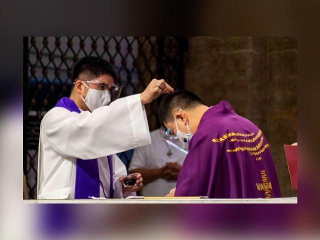 priest sprinkling ashes