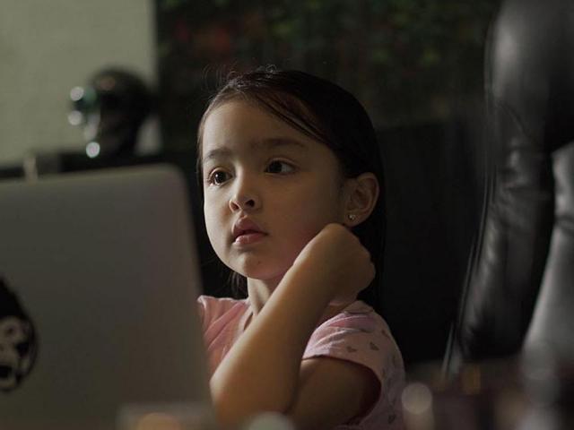 Baby Zia busy on the laptop
