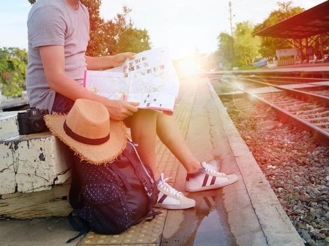 seated main waiting at the traintracks