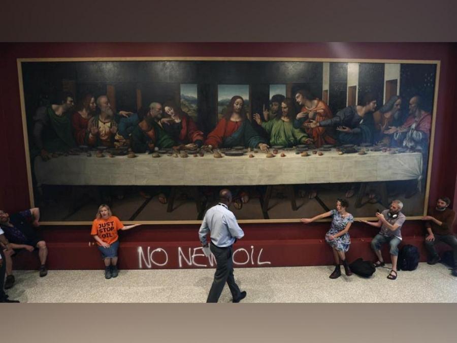 Protesting Last Supper Protestors glue themselves to copy of Da Vinci's 'The Last Supper' to ...