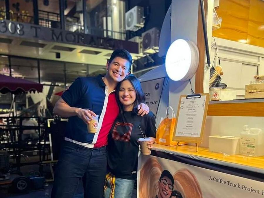 rayver cruz and julie anne san jose beside a coffee truck