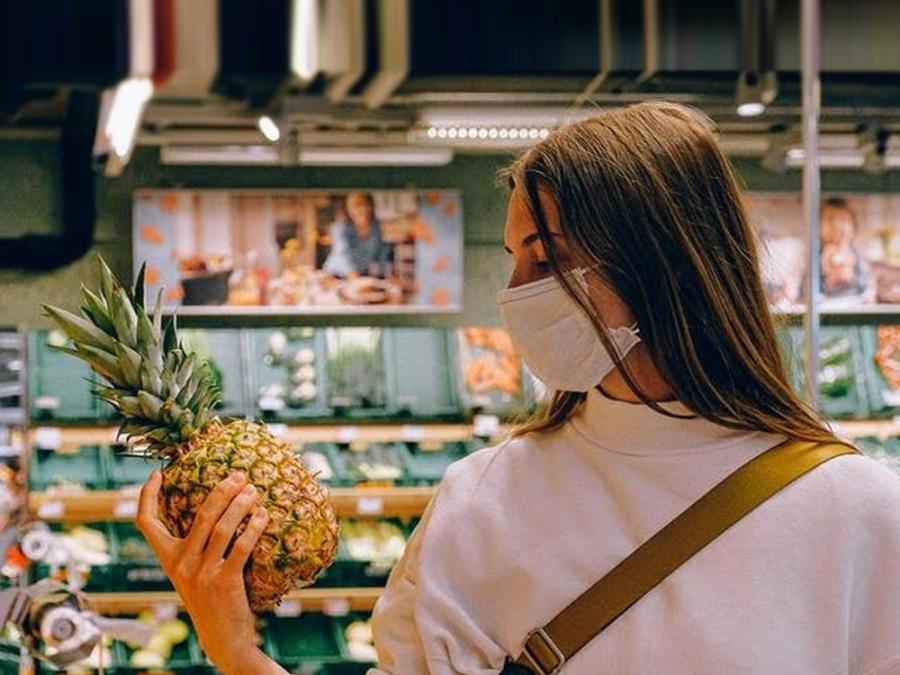 woman checking out a pineapple