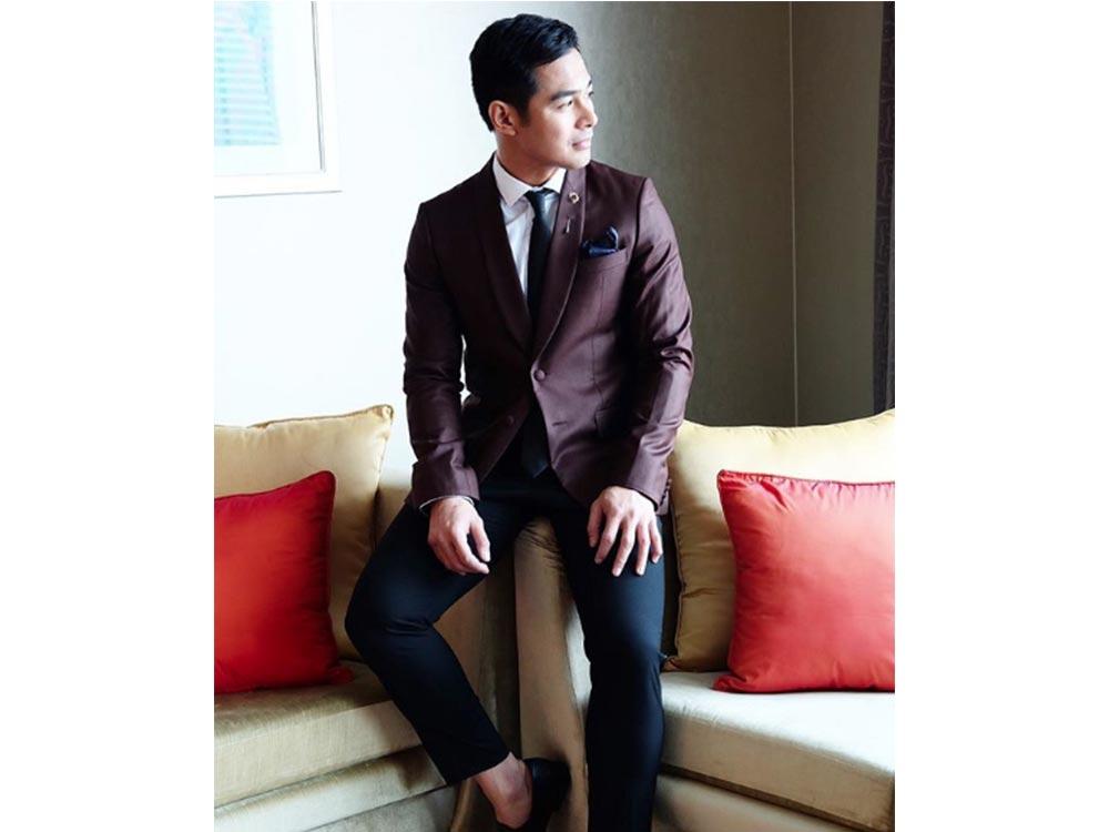 He looks dapper in a suit.