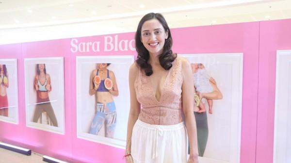 Sara Black posing in front of her Breasts, Be photographs