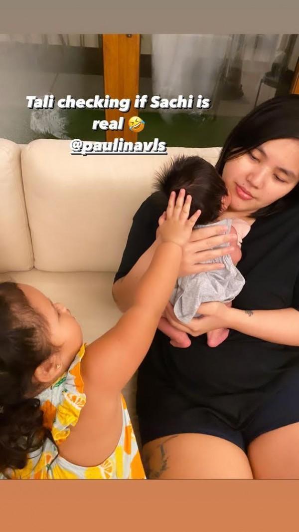 Baby Tali holding baby Sachi