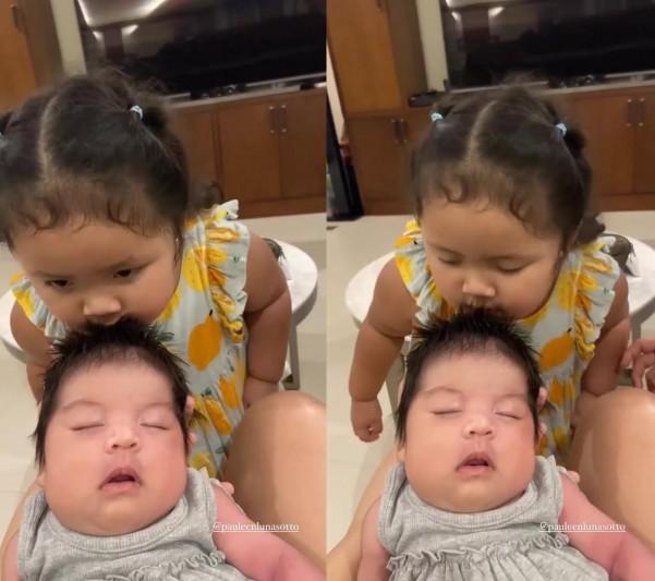 Baby Tali kissing baby Sachi on the head