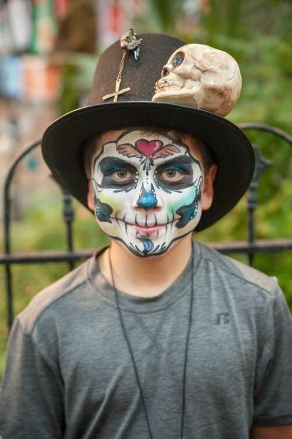 a boy in costume for day of the dead