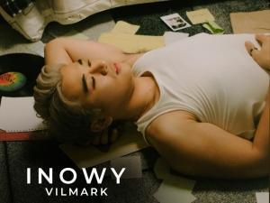 INOWY cover art; Vilmark lying on the floor with his left arm raised and hand placed under his head